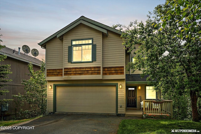 9166 Eagle River Ln, Eagle River, AK 99577 - view of front of home featuring an attached garage, driveway, and covered porch