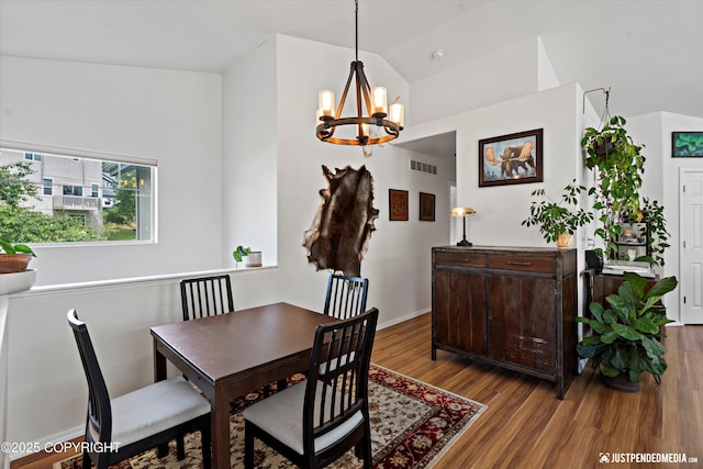 9166 Eagle River Ln, Eagle River, AK 99577 - dining area featuring a chandelier, lofted ceiling, and wood finished floors