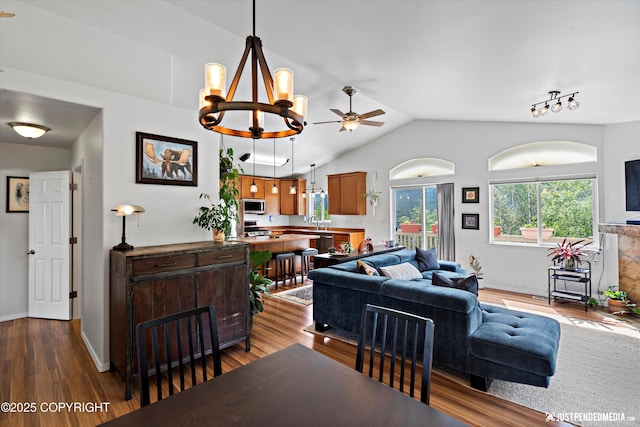 9166 Eagle River Ln, Eagle River, AK 99577 - living area featuring dark wood-style flooring, lofted ceiling, ceiling fan, and a chandelier