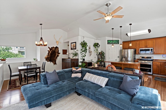 9166 Eagle River Ln, Eagle River, AK 99577 - living room with vaulted ceiling, wood finished floors, a chandelier, and a ceiling fan