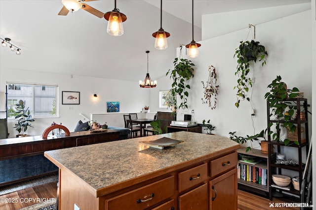 9166 Eagle River Ln, Eagle River, AK 99577 - kitchen featuring lofted ceiling, dark wood finished floors, a center island, a chandelier, and pendant lighting