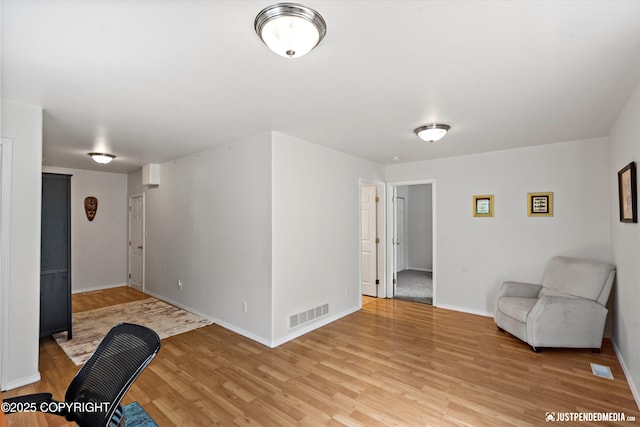 9166 Eagle River Ln, Eagle River, AK 99577 - unfurnished living room featuring light wood-type flooring and baseboards