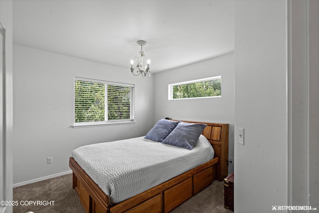 9166 Eagle River Ln, Eagle River, AK 99577 - bedroom featuring dark colored carpet and a chandelier