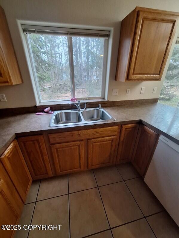 408 Eadies Way, Kenai, AK 99611 - kitchen with white dishwasher, light tile patterned floors, and brown cabinets