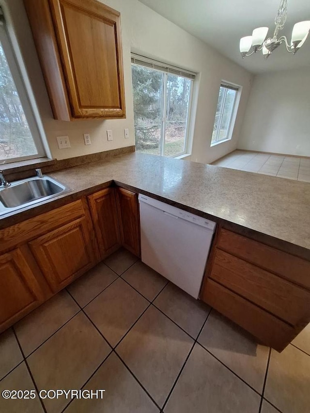 408 Eadies Way, Kenai, AK 99611 - kitchen with white dishwasher, light tile patterned floors, brown cabinetry, and a chandelier