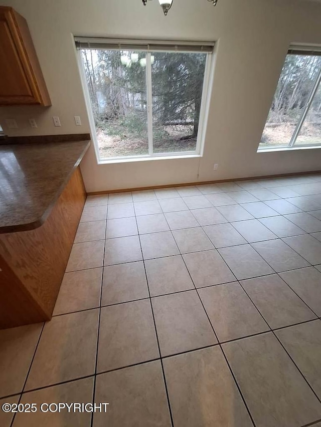 408 Eadies Way, Kenai, AK 99611 - unfurnished dining area featuring light tile patterned floors