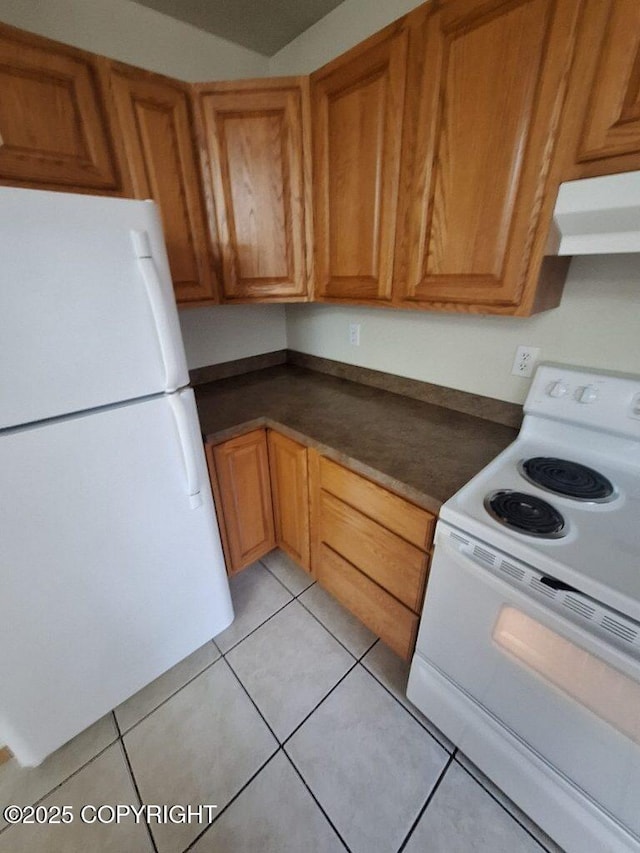 408 Eadies Way, Kenai, AK 99611 - kitchen with white appliances, range hood, dark countertops, and light tile patterned floors