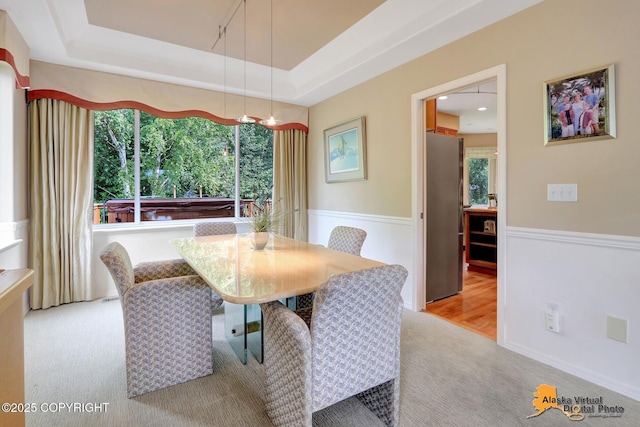 3931 Moonstar Cir, Anchorage, AK 99516 - carpeted dining space with a wainscoted wall and a raised ceiling