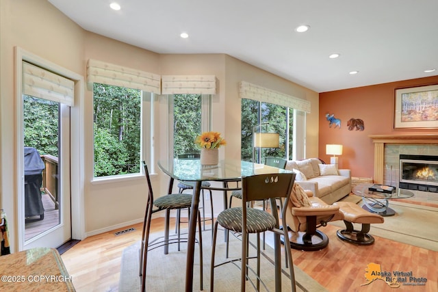3931 Moonstar Cir, Anchorage, AK 99516 - dining area featuring recessed lighting, plenty of natural light, wood finished floors, and a fireplace