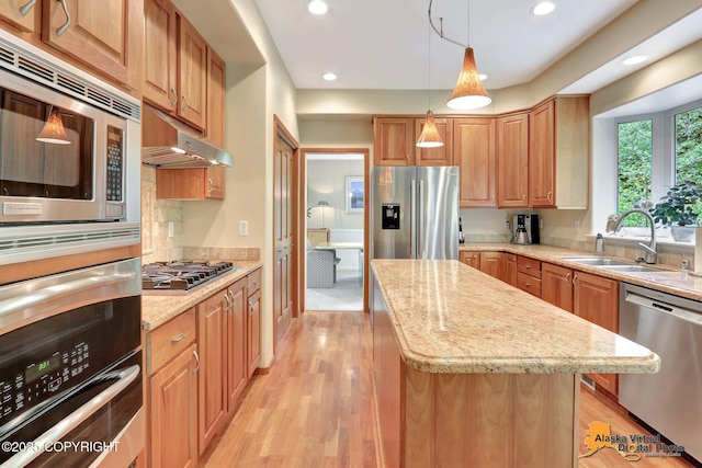 3931 Moonstar Cir, Anchorage, AK 99516 - kitchen with appliances with stainless steel finishes, under cabinet range hood, a kitchen island, light stone countertops, and recessed lighting