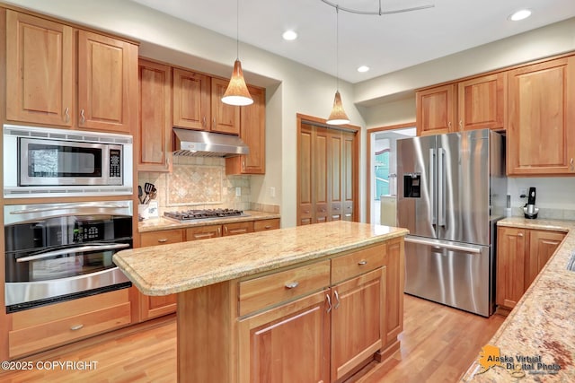 3931 Moonstar Cir, Anchorage, AK 99516 - kitchen with stainless steel appliances, a kitchen island, light wood-style flooring, tasteful backsplash, and recessed lighting