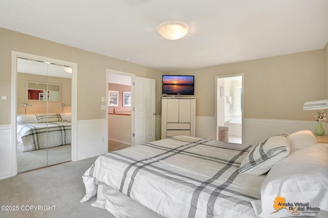 3931 Moonstar Cir, Anchorage, AK 99516 - carpeted bedroom with wainscoting, a closet, and connected bathroom