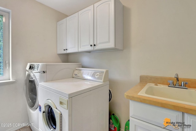 3931 Moonstar Cir, Anchorage, AK 99516 - laundry area featuring separate washer and dryer, cabinet space, and plenty of natural light