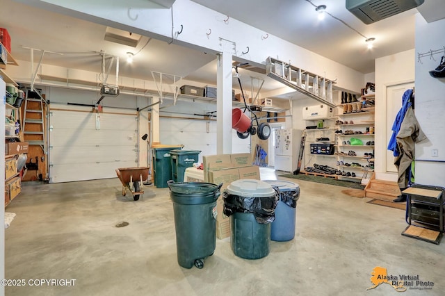 3931 Moonstar Cir, Anchorage, AK 99516 - garage with a garage door opener and freestanding refrigerator