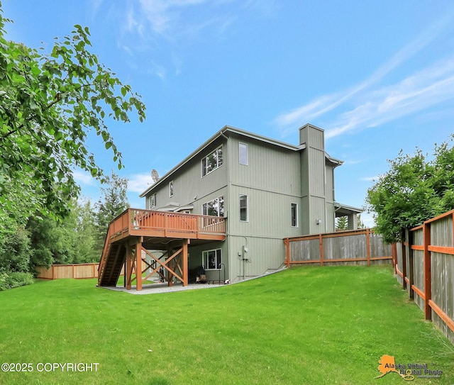 3931 Moonstar Cir, Anchorage, AK 99516 - back of house with stairway, a deck, a fenced backyard, and a chimney