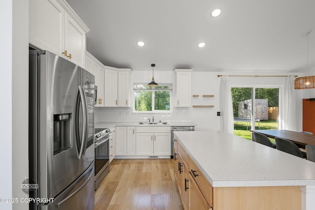 1460 E Esty Dr, Palmer, AK 99645 - kitchen with appliances with stainless steel finishes, light wood-style floors, plenty of natural light, light countertops, and recessed lighting