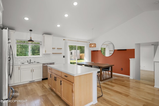 1460 E Esty Dr, Palmer, AK 99645 - kitchen with dishwasher, refrigerator, vaulted ceiling, light wood-style flooring, and a kitchen island