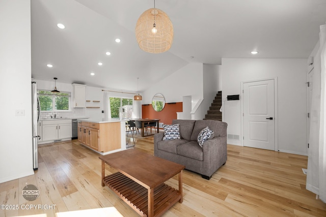 1460 E Esty Dr, Palmer, AK 99645 - living room with stairway, lofted ceiling, light wood-style floors, and recessed lighting