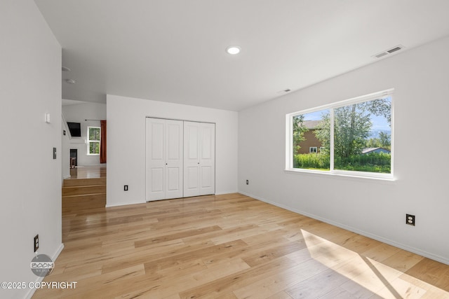 1460 E Esty Dr, Palmer, AK 99645 - unfurnished bedroom featuring light wood-style floors, recessed lighting, a closet, and a fireplace