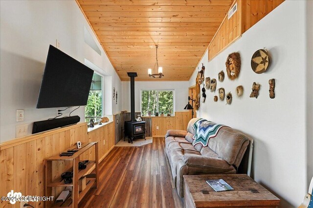 18095 Langille Rd, Cooper Landing, AK 99572 - living room with a wood stove, wood walls, wainscoting, hardwood / wood-style flooring, and wooden ceiling