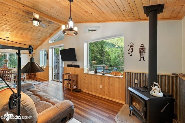 18095 Langille Rd, Cooper Landing, AK 99572 - living room with a wood stove, wood ceiling, hardwood / wood-style flooring, wainscoting, and wood walls