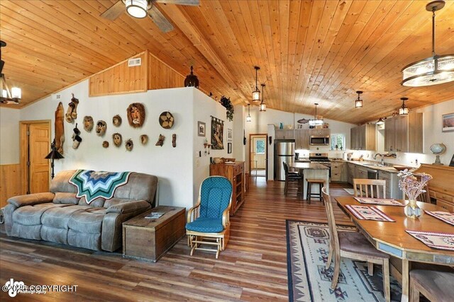 18095 Langille Rd, Cooper Landing, AK 99572 - living area with vaulted ceiling, wood ceiling, dark wood finished floors, ceiling fan, and wooden walls