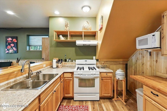 18095 Langille Rd, Cooper Landing, AK 99572 - kitchen with white appliances, under cabinet range hood, light wood-style flooring, open shelves, and a peninsula