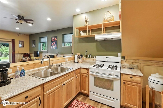 18095 Langille Rd, Cooper Landing, AK 99572 - kitchen featuring white gas range, under cabinet range hood, a ceiling fan, light wood-style flooring, and recessed lighting