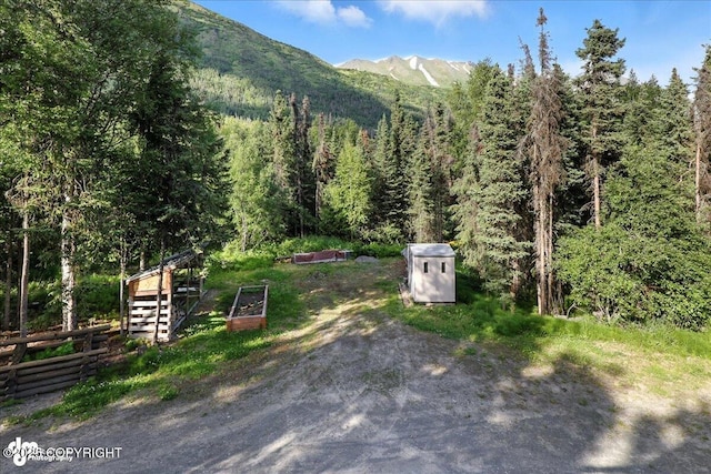 18095 Langille Rd, Cooper Landing, AK 99572 - view of mountain backdrop with a heavily wooded area