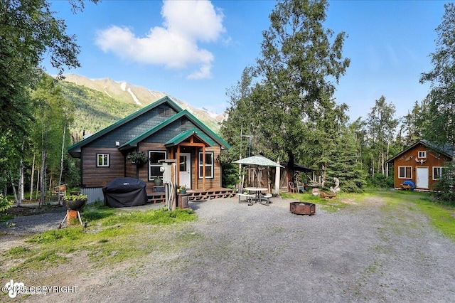 18095 Langille Rd, Cooper Landing, AK 99572 - view of front of property featuring an outdoor fire pit and a mountain view