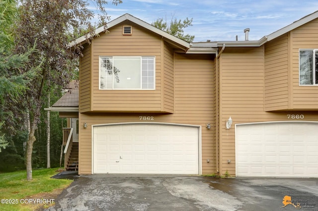 7862 Spruce St Unit 7B, Anchorage, AK 99507 - view of front of home with a garage and driveway