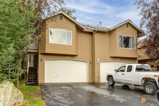 7862 Spruce St Unit 7B, Anchorage, AK 99507 - view of front of house featuring a garage and driveway