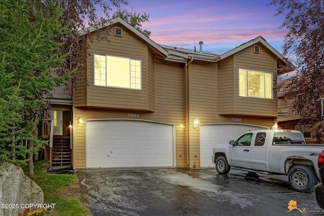 7862 Spruce St Unit 7B, Anchorage, AK 99507 - view of front facade featuring an attached garage and asphalt driveway