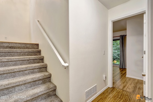 7862 Spruce St Unit 7B, Anchorage, AK 99507 - staircase with wood finished floors and baseboards