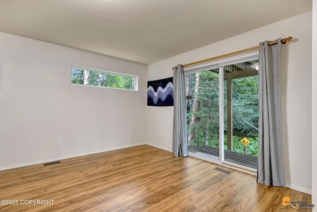 7862 Spruce St Unit 7B, Anchorage, AK 99507 - unfurnished room featuring wood finished floors and baseboards
