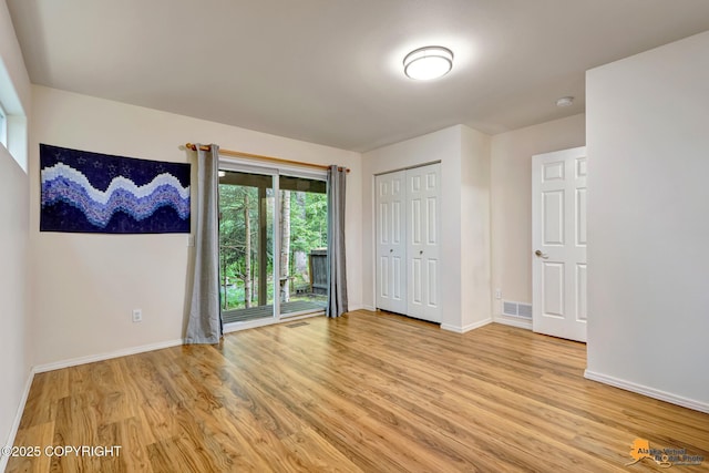 7862 Spruce St Unit 7B, Anchorage, AK 99507 - unfurnished bedroom with light wood-style floors and access to exterior