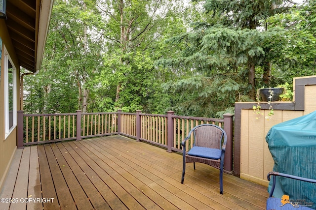 7862 Spruce St Unit 7B, Anchorage, AK 99507 - wooden terrace featuring area for grilling and view of wooded area