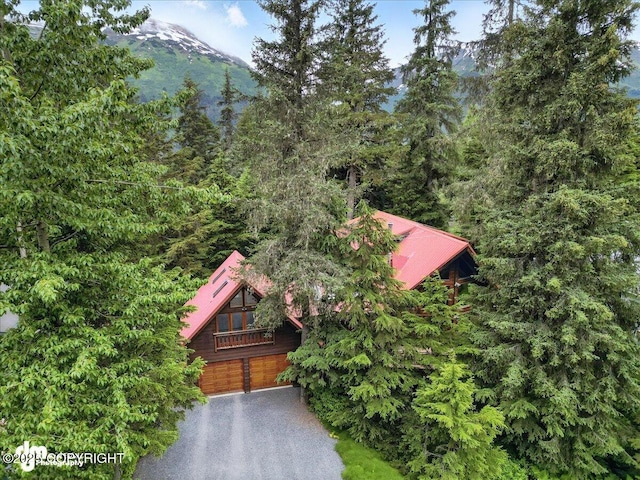 311 Alpine Meadows Ave, Girdwood, AK 99587 - view of front of house with a mountain view, a garage, and driveway