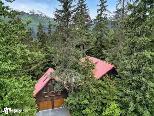 311 Alpine Meadows Ave, Girdwood, AK 99587 - view of property location with a mountain backdrop and a heavily wooded area
