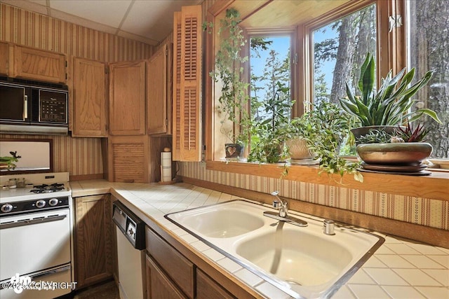 311 Alpine Meadows Ave, Girdwood, AK 99587 - kitchen with tile counters, white appliances, and brown cabinets