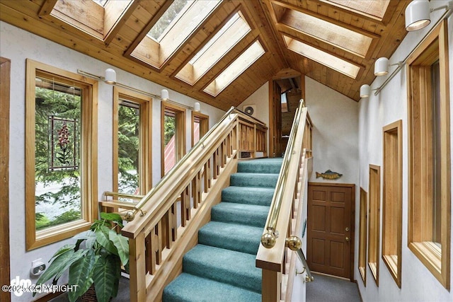 311 Alpine Meadows Ave, Girdwood, AK 99587 - staircase featuring a skylight, healthy amount of natural light, carpet floors, and vaulted ceiling