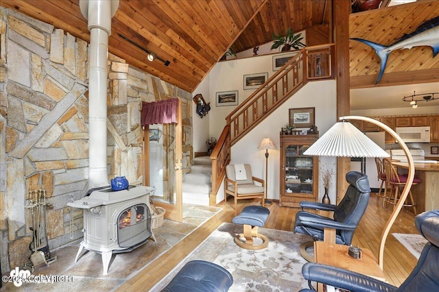 311 Alpine Meadows Ave, Girdwood, AK 99587 - living room with hardwood / wood-style flooring, a wood ceiling with exposed beams, a wood stove, stairway, and high vaulted ceiling