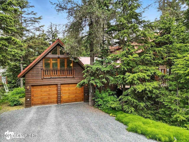 311 Alpine Meadows Ave, Girdwood, AK 99587 - view of front of house featuring asphalt driveway, an attached garage, and a metal roof