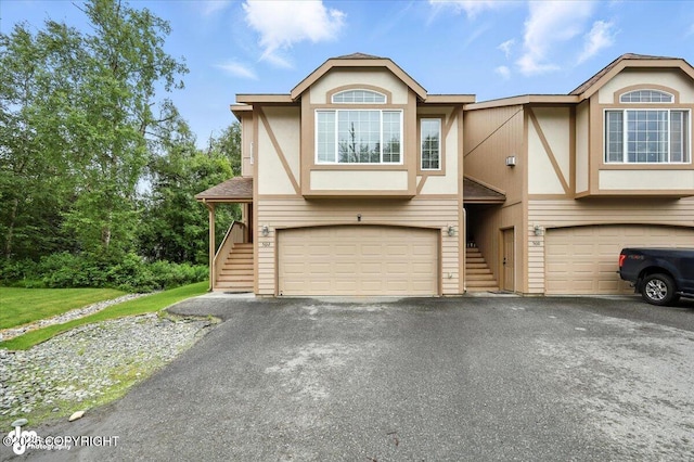 5612 E Beaver Ave, Wasilla, AK 99654 - view of front facade featuring stairway, a garage, stucco siding, and asphalt driveway