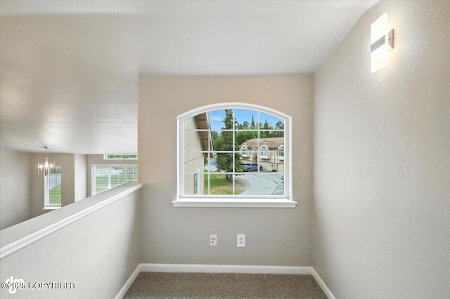 5612 E Beaver Ave, Wasilla, AK 99654 - carpeted spare room with a chandelier and plenty of natural light