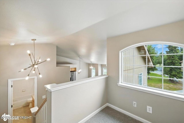 5612 E Beaver Ave, Wasilla, AK 99654 - corridor with an upstairs landing, a chandelier, healthy amount of natural light, vaulted ceiling, and carpet