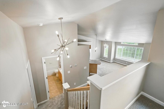 5612 E Beaver Ave, Wasilla, AK 99654 - staircase featuring a chandelier, carpet flooring, and lofted ceiling