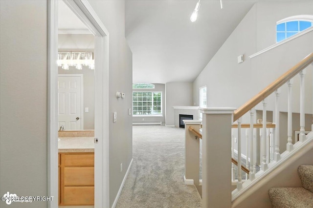 5612 E Beaver Ave, Wasilla, AK 99654 - hall with carpet flooring, stairs, a baseboard radiator, a chandelier, and lofted ceiling