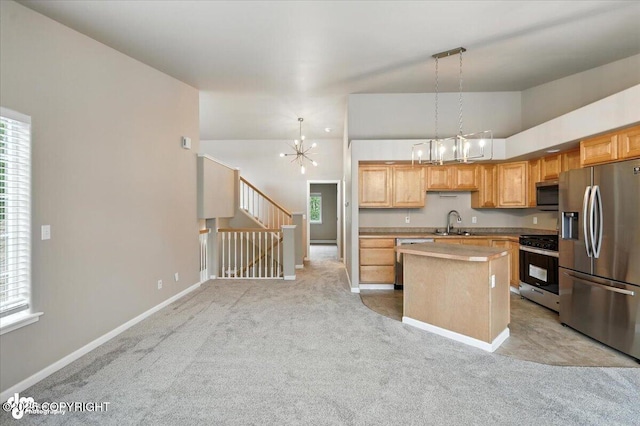 5612 E Beaver Ave, Wasilla, AK 99654 - kitchen featuring appliances with stainless steel finishes, a chandelier, plenty of natural light, light carpet, and lofted ceiling