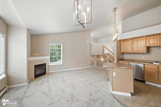 5612 E Beaver Ave, Wasilla, AK 99654 - kitchen featuring stainless steel dishwasher, lofted ceiling, a chandelier, a tiled fireplace, and light countertops